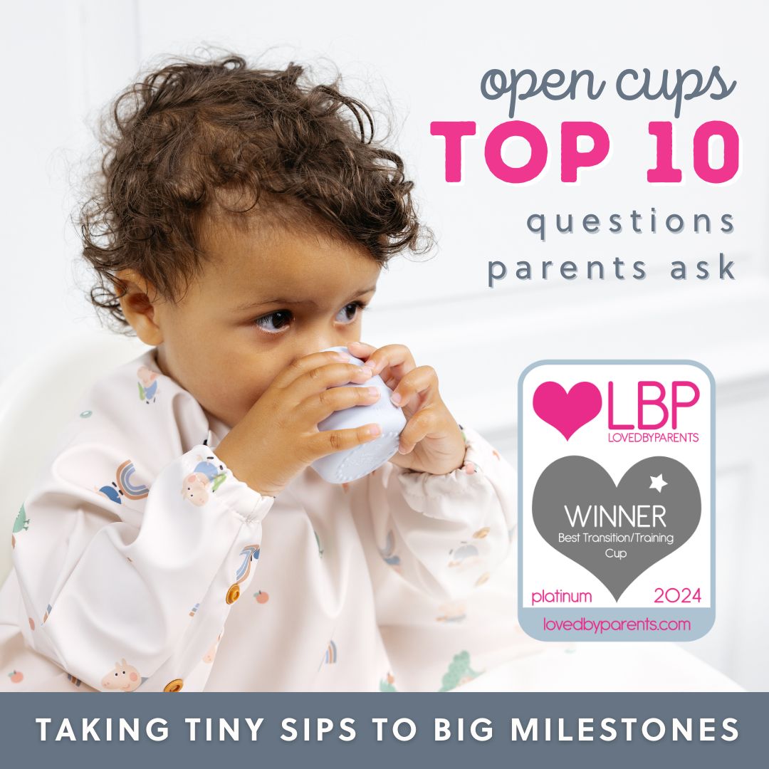 Toddler in a patterned bib sips from a light blue open cup, next to a "LovedByParents Winner" badge.