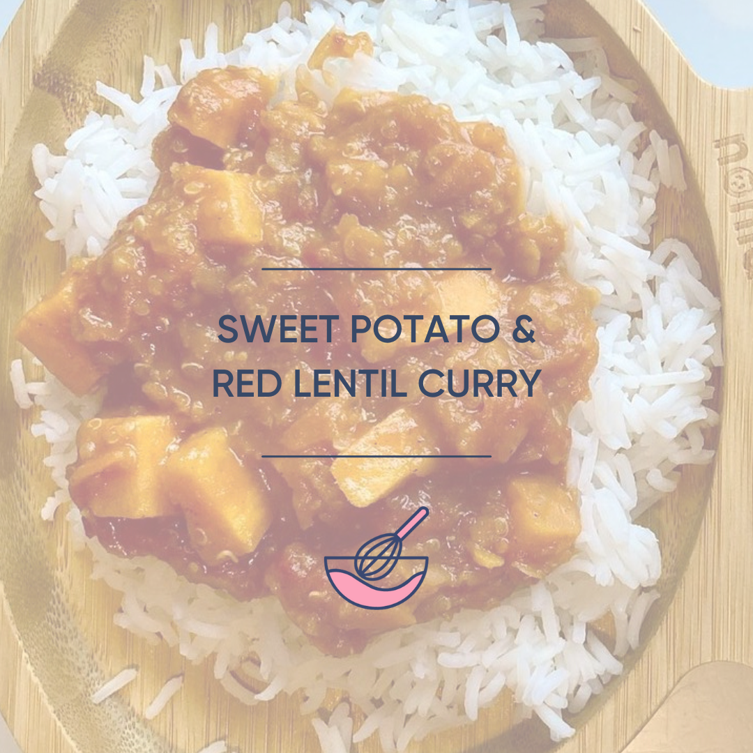 Sweet potato and red lentil curry served on white rice in a wooden bowl.