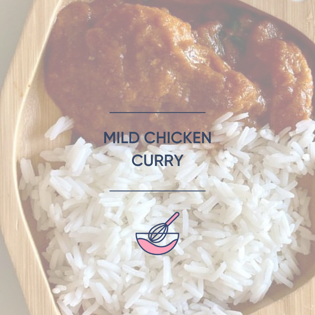 Mild chicken curry with fluffy white rice in a wooden bowl.