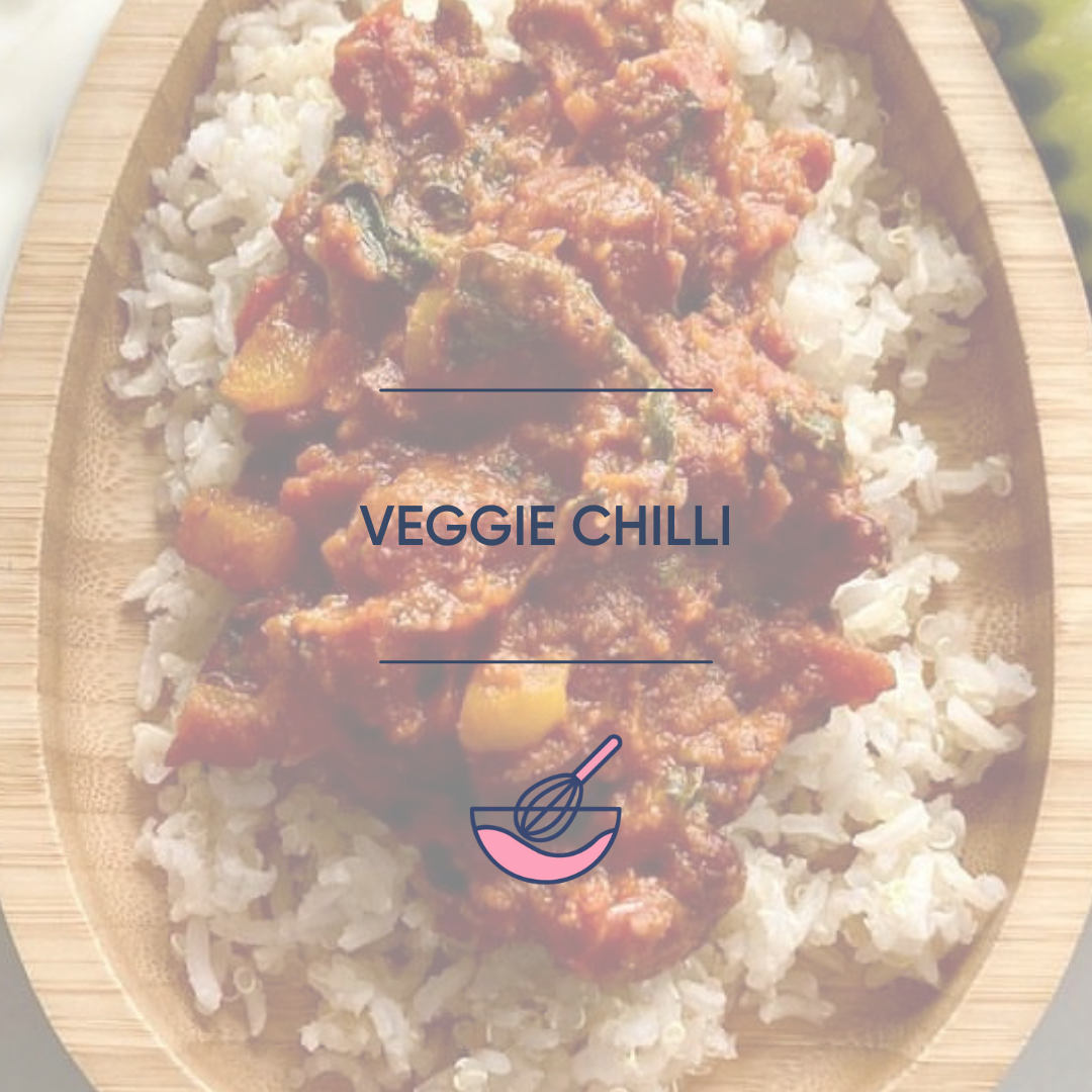 Hearty veggie chilli with rice served in a light wooden bowl.
