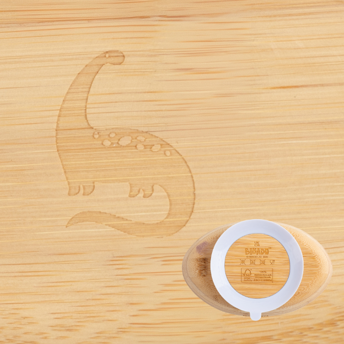 Natural bamboo suction bowl with a white silicone ring and a subtle dinosaur engraving. - Product image