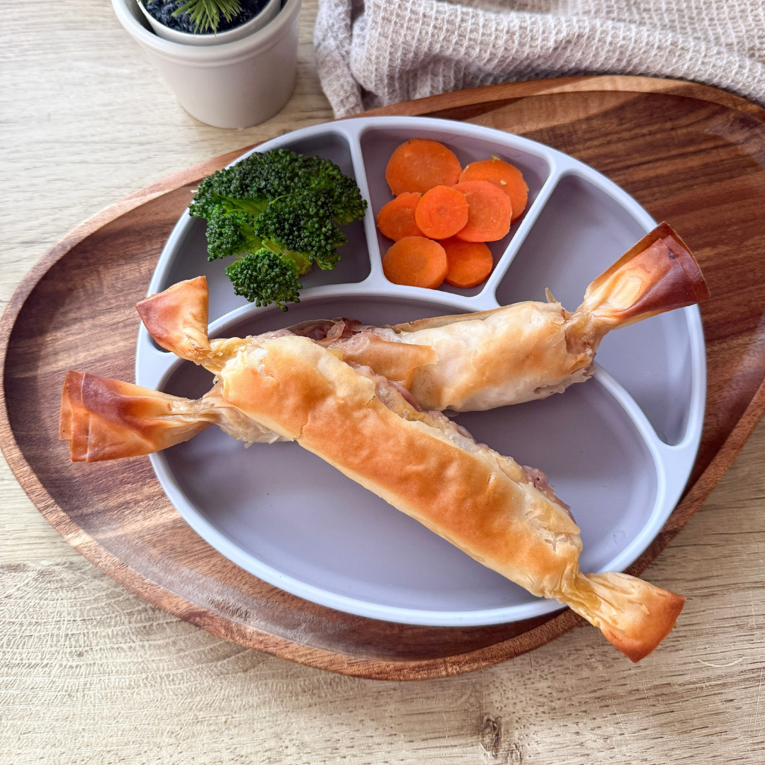 Flaky pastry crackers filled with turkey and stuffing, served with broccoli and carrots.