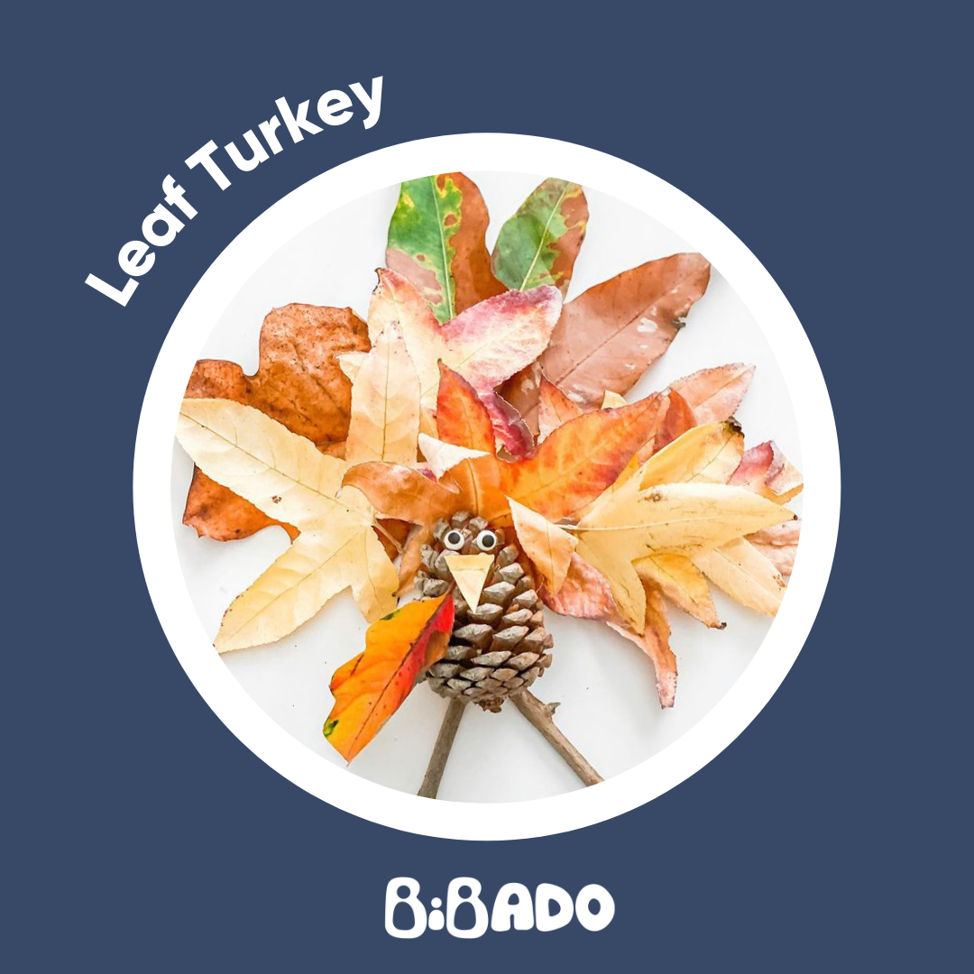 Autumn leaf turkey craft with a pinecone body and colourful fallen leaves as feathers.
