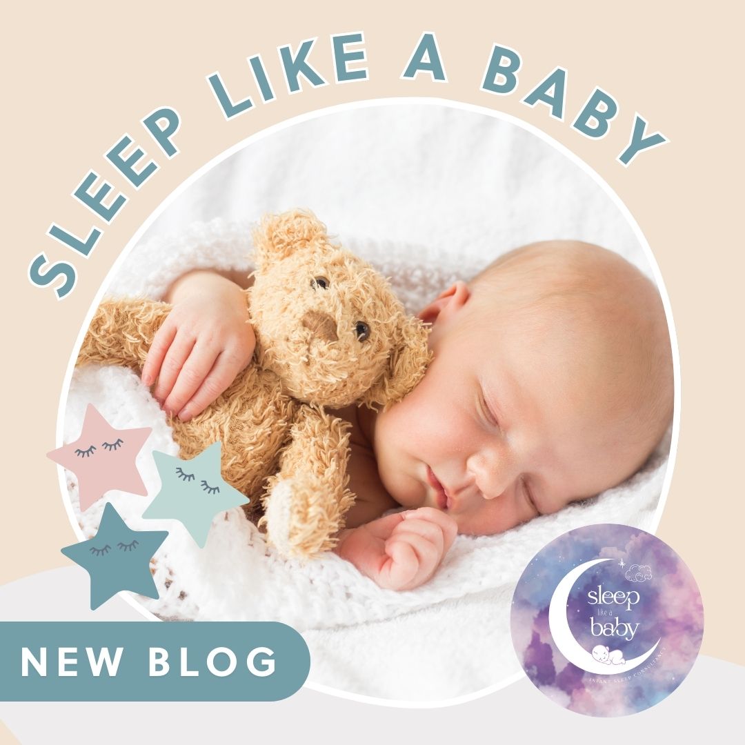 Newborn baby sleeping peacefully, cuddled with a brown teddy bear under a white knitted blanket.