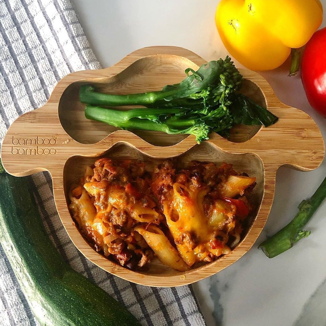 Chilli pasta bake with broccoli served on a bamboo toddler plate.