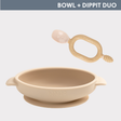 Beige silicone baby bowl with suction base and matching soft-tip spoon, both with "BIBADO" logo.