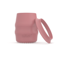 A pink silicone baby drinking cup with a removable silicone skirted base propped against it, shown on a clean white background. 