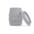 A light blue-grey silicone baby drinking cup with a removable silicone skirted base propped against it, shown on a clean white background. 