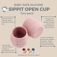 Two pink silicone Sippit open training cups with ridged sides and weighted bases.