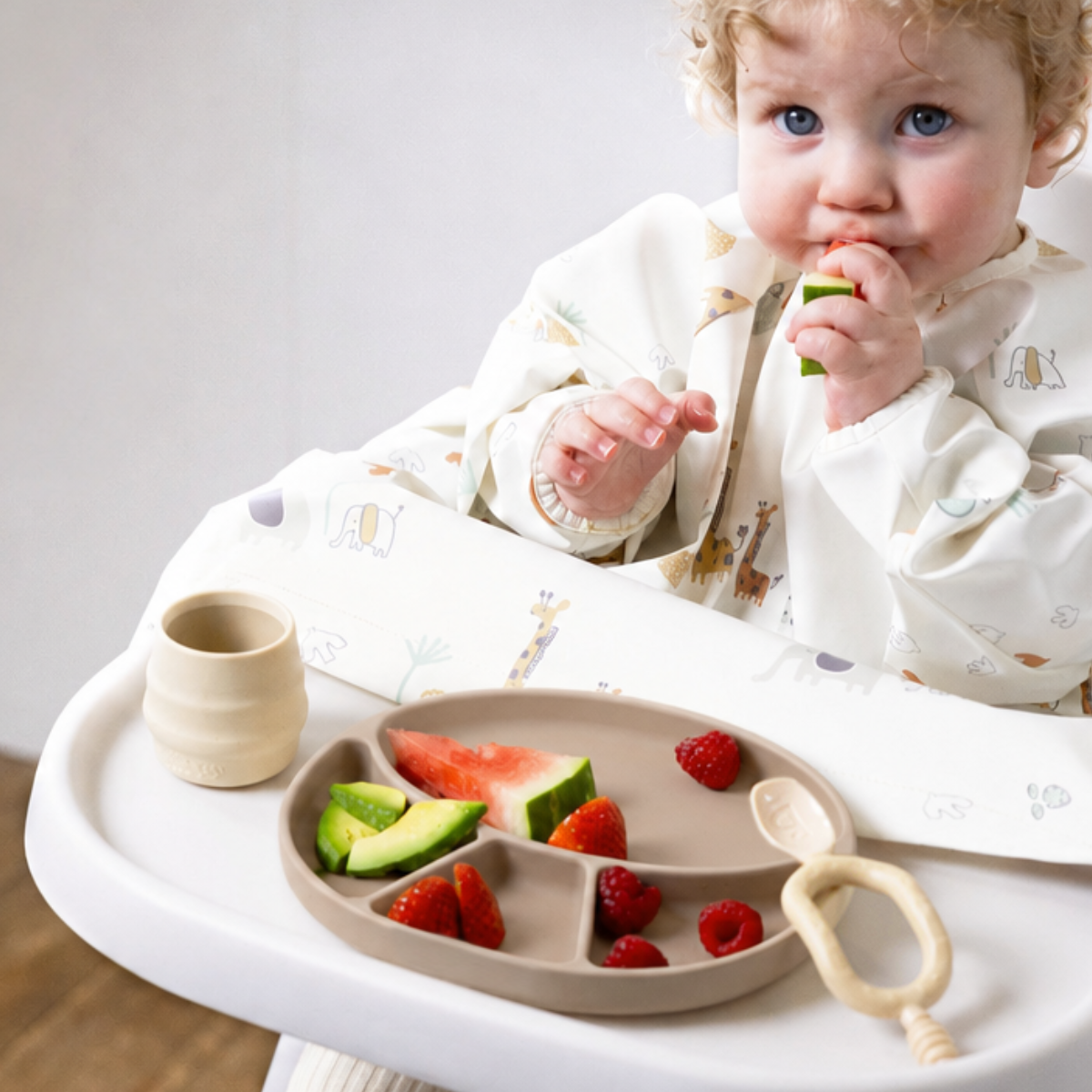 Child wearing safari Coverall bib eating fruits from fawn silicone plate - Product image